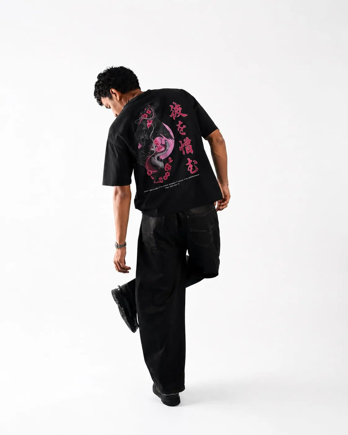 Model wearing Sakura Raven Oversized T-Shirt showcasing Japanese-inspired raven graphic on the back